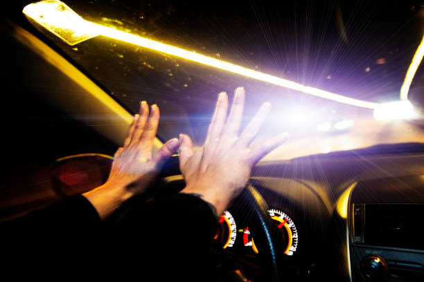 istock Womans hands on car steering wheel at night 859579274