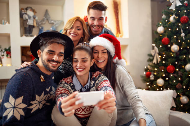 istock friends taking photo with mobile phone for Christmas 859580702