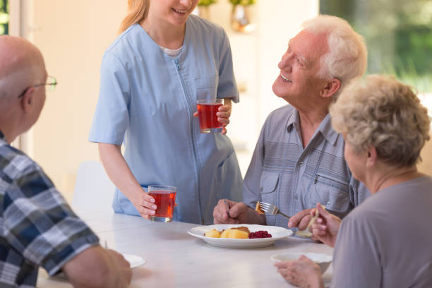 istock Nurse giving juice to seniors 859584348