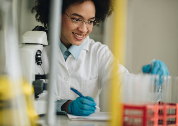 istock Happy African American scientist examining scientific data of an experiment. 859587368