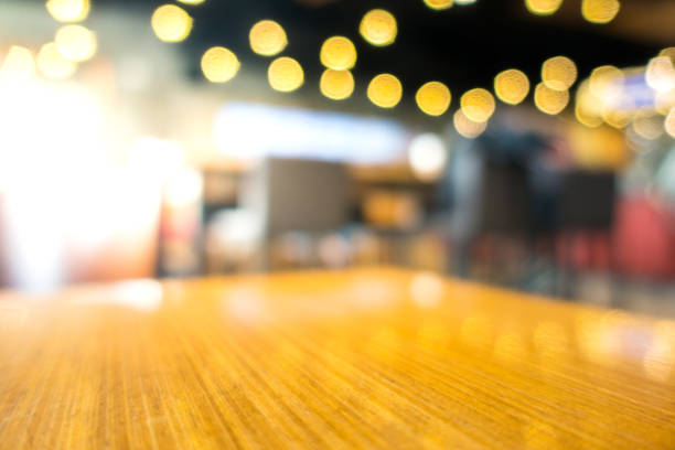 istock Empty wood table with blur in coffee shop or cafe background.For montage product display. 859587430