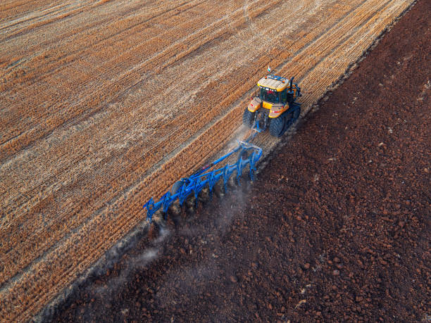 istock Tractor cultivating field at autumn, aerial view 859587482
