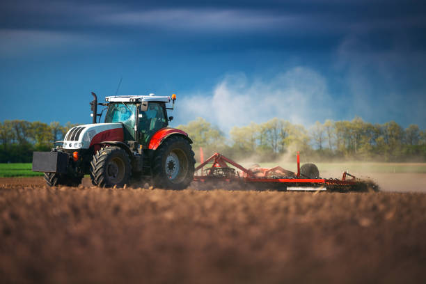istock Farmer in tractor preparing land with seedbed cultivator, sunset 859588246