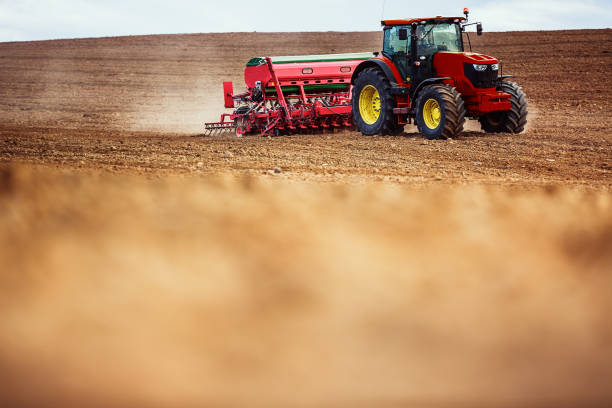istock Farmer in tractor preparing farmland with seedbed for the next year 859588376