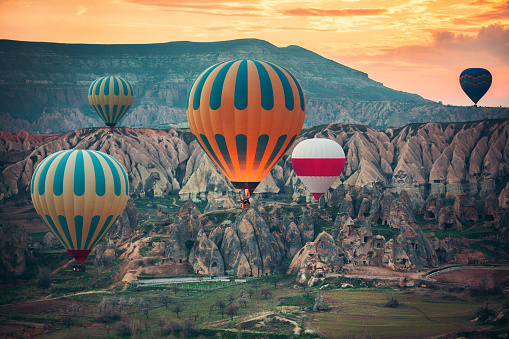 Hot air balloons flying over the valley at Cappadocia, Turkey.