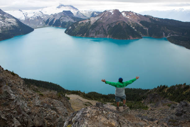 istock Male hiker embracing nature with arms outstretched 859591202