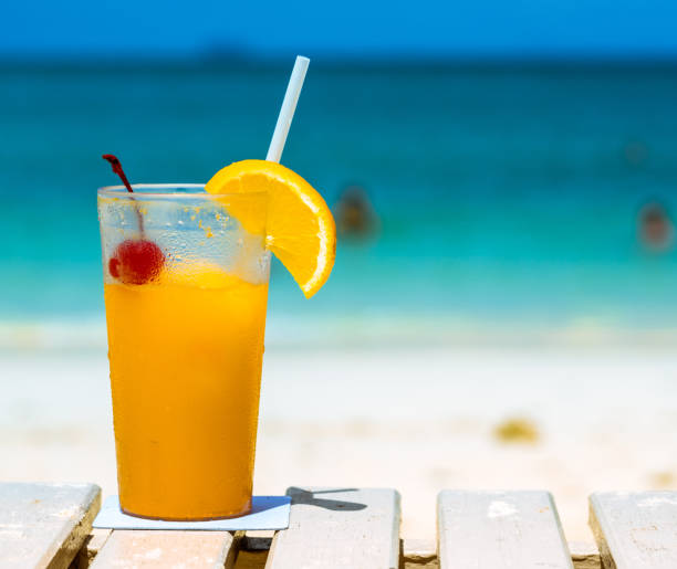 istock orange juice drink on the beach table, summer fresh cool water for relaxation, copy space. 859593436
