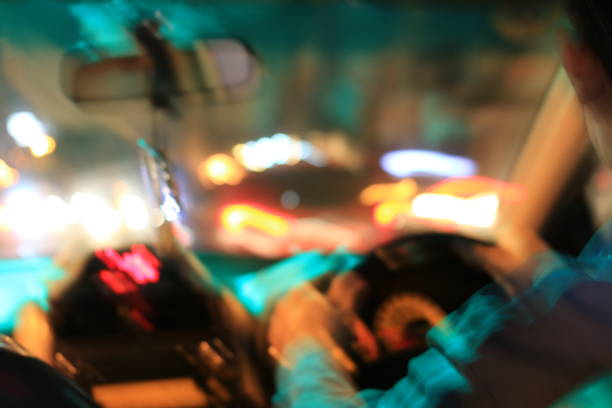 night road view from inside car natural light street and other cars is motion blurred, blur image from inside a car traveling at night time. - city vitality speed highway imagens e fotografias de stock