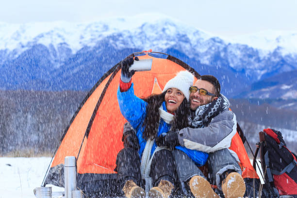 istock Couple backpackers taking selfie in front of a tent 859600726