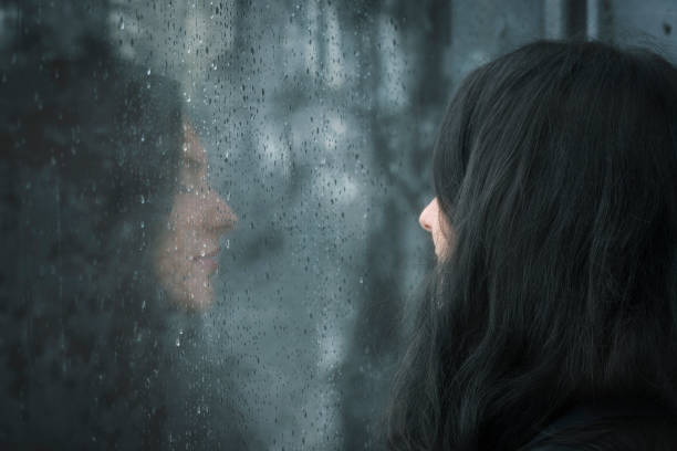 istock Woman in front of rainy window 859600872