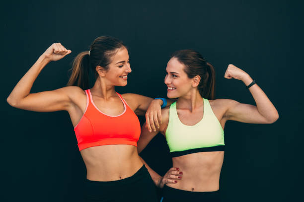 istock Sportswomen flexing their muscles 859601162