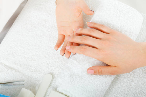 istock Woman hand on towel, next to manicure set 859604228