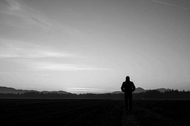 istock Monochrome rear view of silhouetted person 859604856