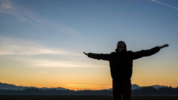 istock Young person celebrating the sunrise or sunset 859605022