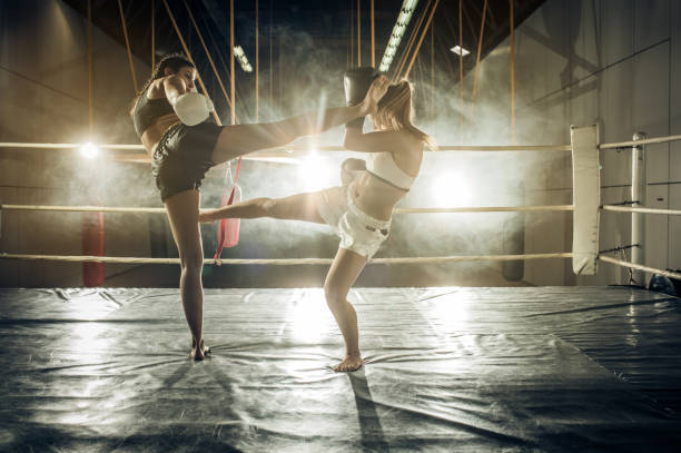 istock Two tough women dueling in a fighting ring. 859605084