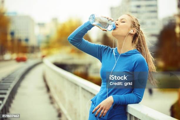 Woman Exercise On The Bridge Stock Photo - Download Image Now - Drinking Water, Exercising, Women