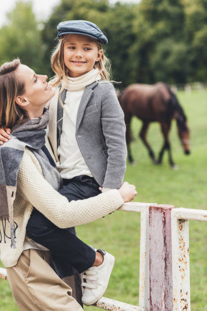istock happy family at paddock with horse 859607640