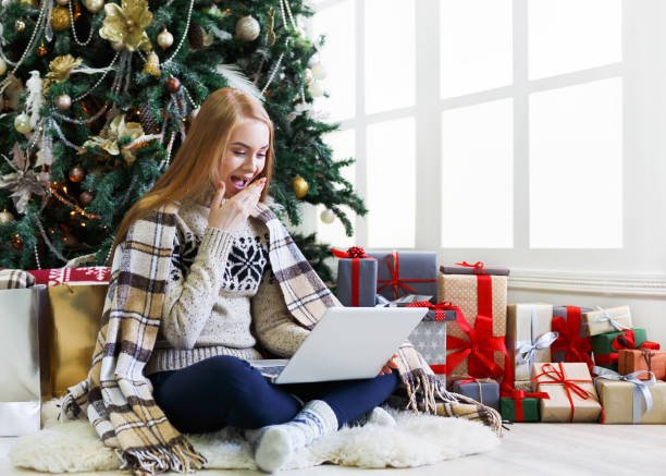 istock Surprised woman online on laptop at christmas interior 859611006