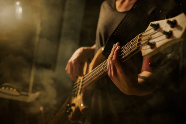 istock The bass guitar player plays solo. 859612002