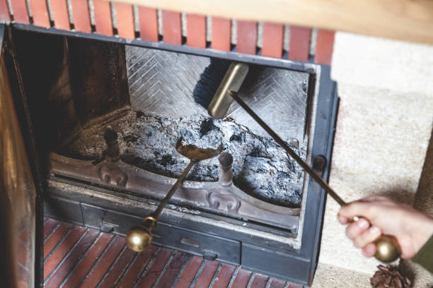 istock man cleans fireplace with brush and blades 859612048