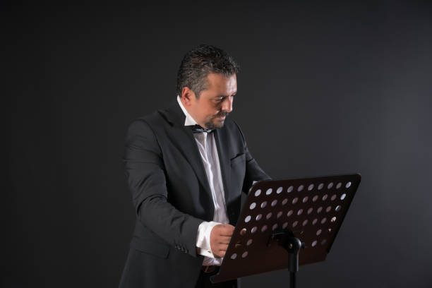 Studio photo of music conductor over black background