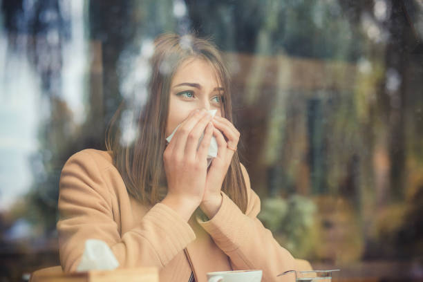 Young woman got nose allergy, flu sneezing nose stock photo
