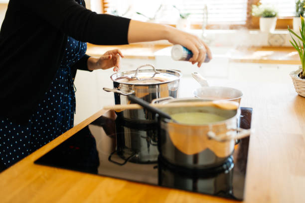 istock Woman adding spices to food 859616550