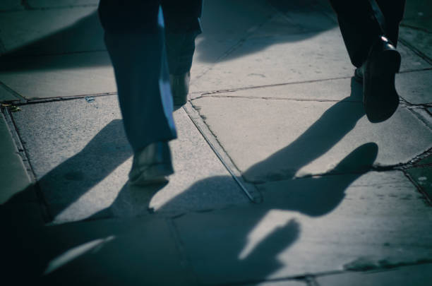 istock Two Businessmen Walking on City Sidewalk 859619296