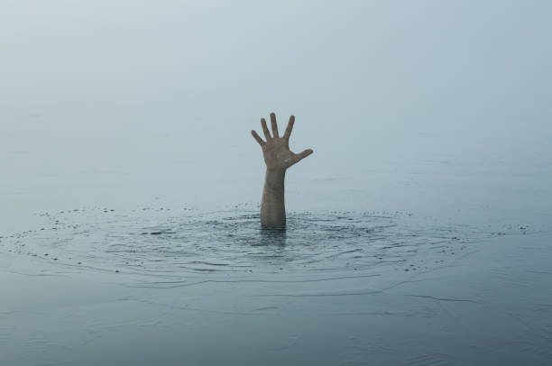 Hand of a sinking man Danger, problems concept. Close up of human hand drowning in the lake man hand down stock pictures, royalty-free photos & images