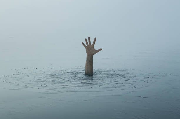 hand of a sinking man - human hand reaching human arm gripping imagens e fotografias de stock