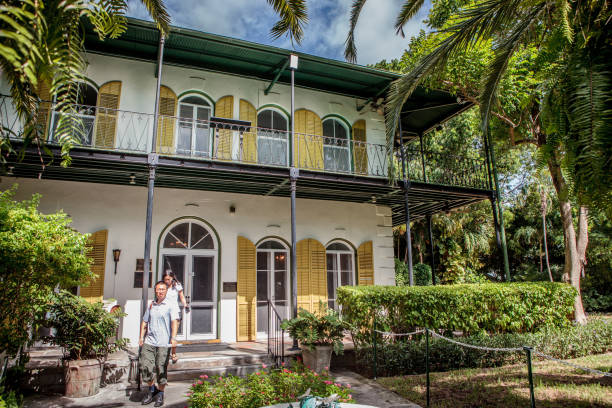 Hemingway Museum in Key West, Florida Key West, Florida - October 6, 2016: Tourists visit the Hemingway House, the home of famous author Ernest Hemingway, which is now a museum. hemingway house stock pictures, royalty-free photos & images