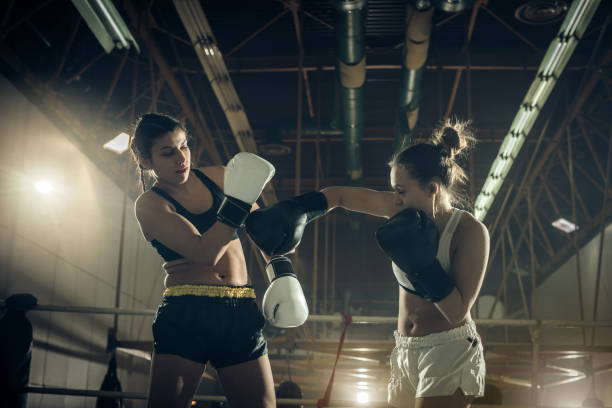istock Two young women fighting during a boxing match in a ring. 859620638