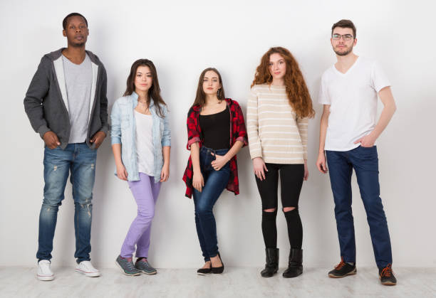 istock Group of diverse students standing in line indoors 859623944