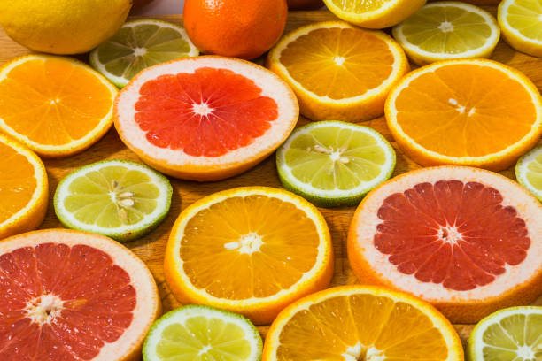 istock Citrus fruit background with sliced f oranges lemons lime tangerines and grapefruit 859626880