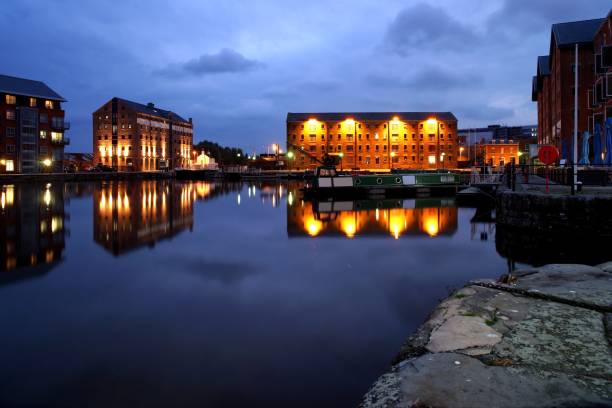 Gloucester Quays in the night. Gloucester Quays in the night. Dark blue sky. Warehouses. gloucestershire stock pictures, royalty-free photos & images