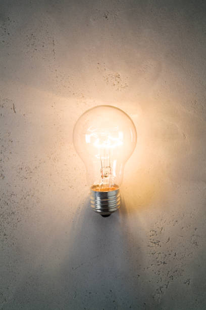 Vintage incandescent bulb on concrete background
