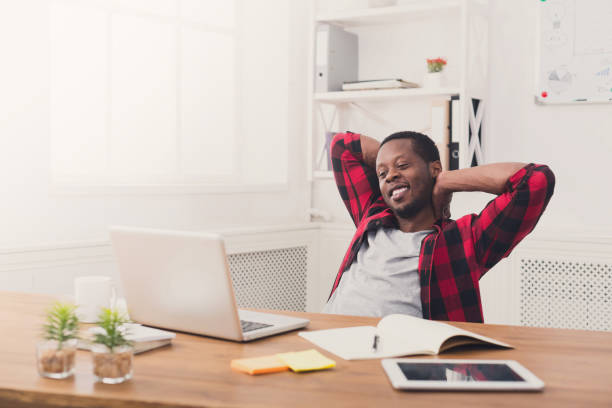 istock Young relaxed businessman with laptop in modern white office 859631092
