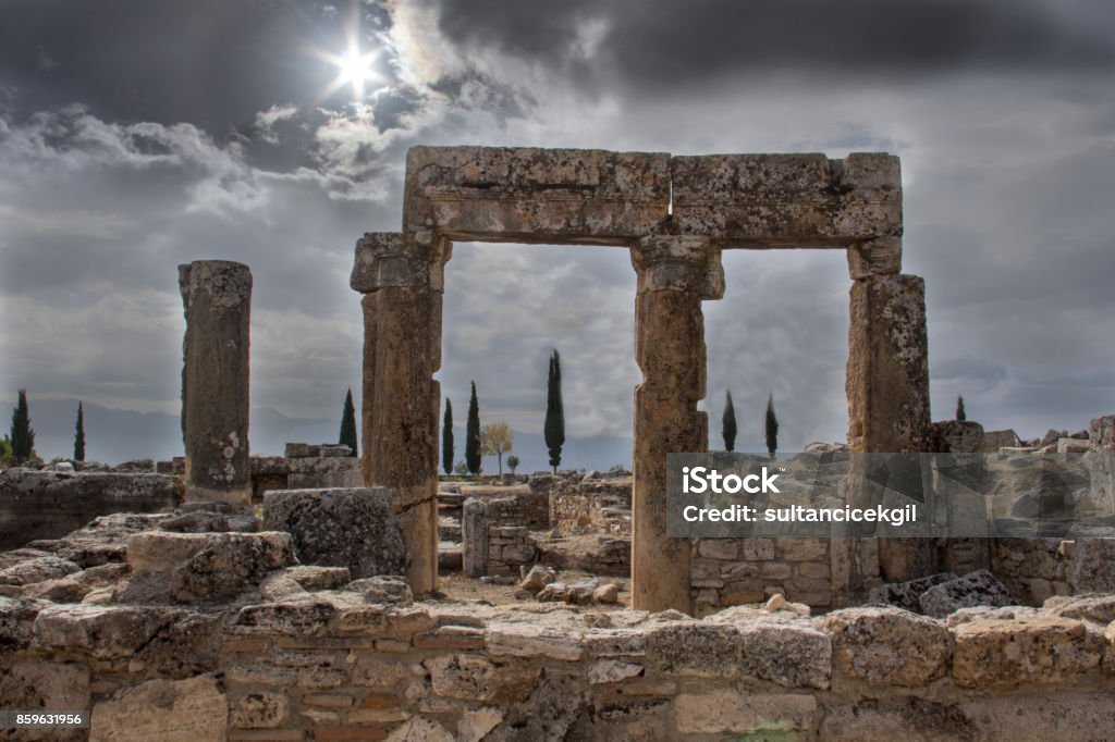 Roman city gate in Hierapolis, Pamukkale, Turkey. Famous Place, Hot Spring, International Landmark, National Landmark, Old Ruin Altostratus Stock Photo