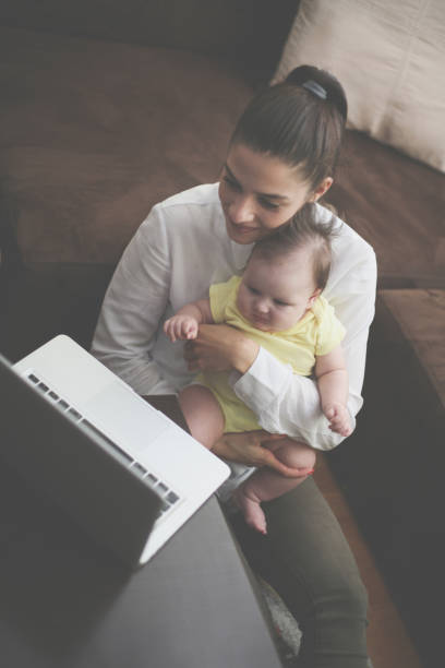 istock Young mother with baby at home. 859632294