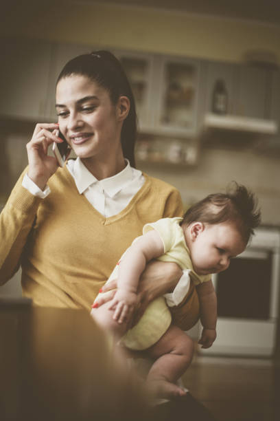 istock Mother working at home with baby. 859635226