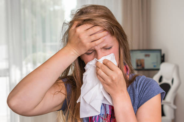 istock Sick woman with flu or cold sneezing into handkerchief 859635328