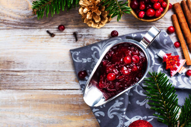 istock Cranberry sauce with ingredients on wooden table 859635988