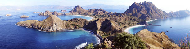 Panoramic view of Padar Island with three bays and sandy beaches in Flores. High Panoramic scenic view of Padar Island with  three beautiful bays and sandy beaches surrounded by a wide ocean and part of komodo national park in Flores, Indonesia. pulau komodo stock pictures, royalty-free photos & images