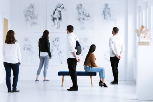 Visitors in art gallery Visitors in art gallery with drawings and sculpture during cultural meeting. Art gallery concept gallery opening stock pictures, royalty-free photos & images