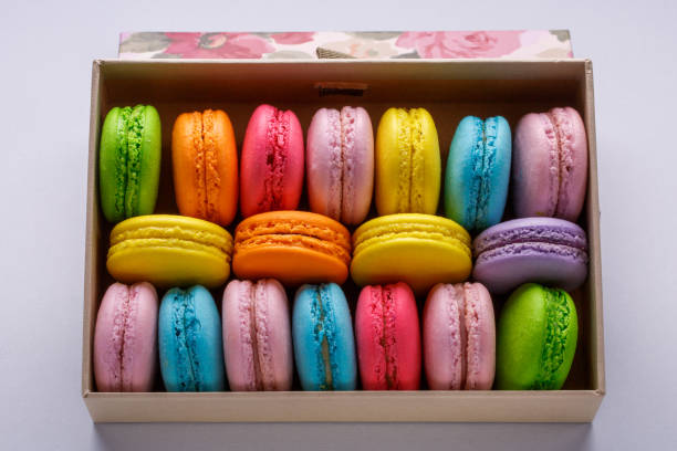 istock Colorful macaroons in a gift box on gray background. Sweet macarons. 859639406