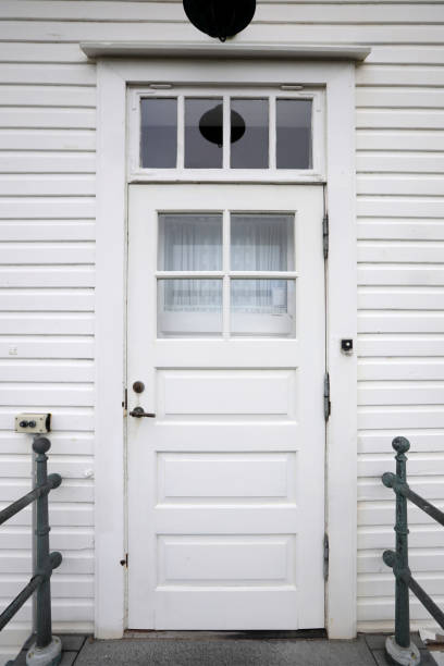 istock Door on a wooden white house 859643660