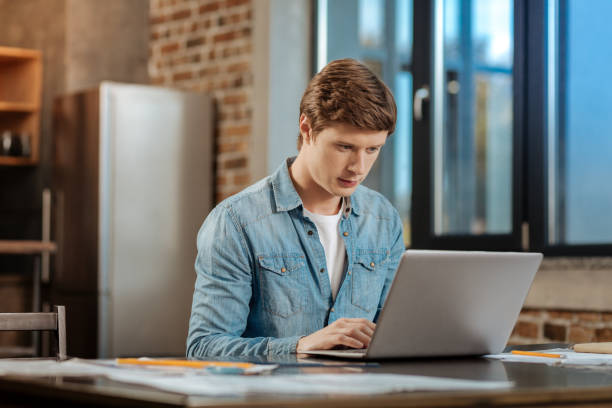 istock Pleasant young man working on the laptop 859646012