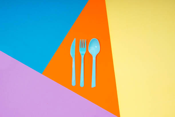 istock Spoon,knife,fork on orange,yellow,purple and blue Colored paper background 859646062