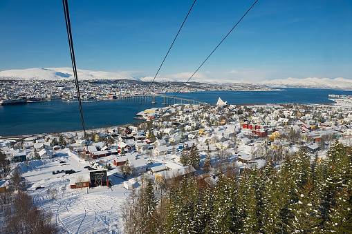 Tromso, Norway - March 29, 2011: View to the Tromso city from the Fjellheisen aerial tramway cabin in Tromso, Norway.