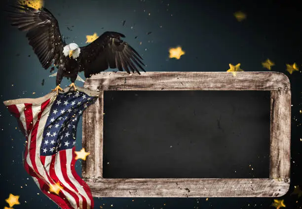 Photo of Empty wooden table with bald eagle and USA flag background